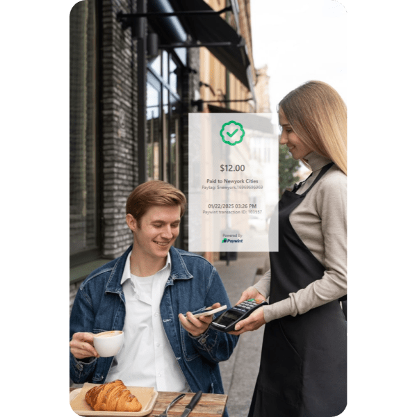 Paywint POS: A Smarter Way to Manage Transactions A Customer Using Paywint POS To Make A Seamless Payment At An Outdoor Café, Showcasing Secure And Convenient Transaction Solutions