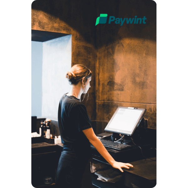 Why Choose POS Systems? A Restaurant Worker Using A Paywint POS System To Manage Transactions Efficiently