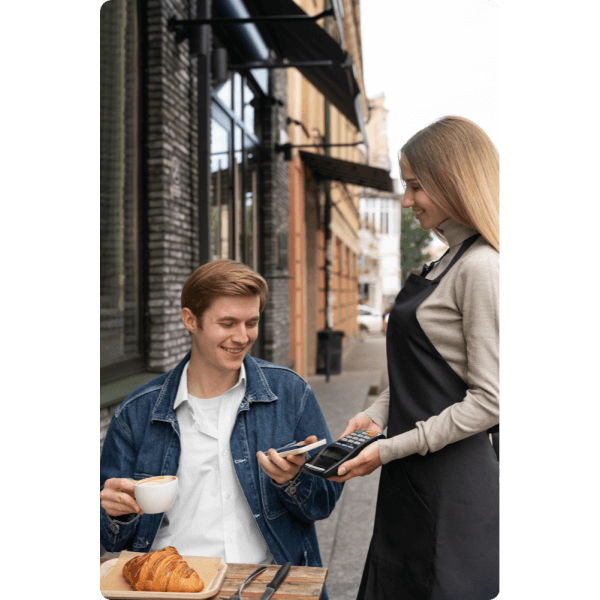 Boost Your Business with Smarter Transactions A Man Enjoys Coffee While Checking His Phone, Illustrating How Paywint Simplifies Cash Transfers