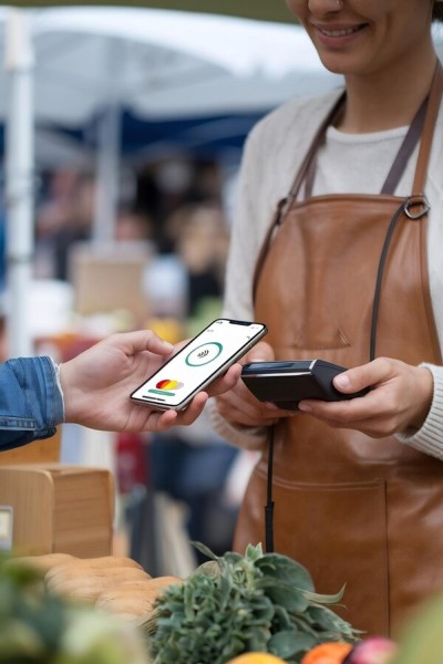 Faster Checkouts & Better Customer Experience A Man Enjoys Coffee While Checking His Phone, Illustrating How Paywint Simplifies Cash Transfers