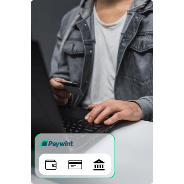 Multiple Payment Methods for Convenience A Man in a Blue Sweater Using a Laptop While a Paywint Checkout Screen Is Displayed Above Him