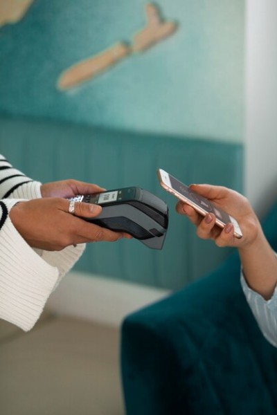 Reliable Credit Card Payment Terminal for Businesses Close-Up of a Contactless Payment Transaction Using a Mobile Phone and POS Terminal