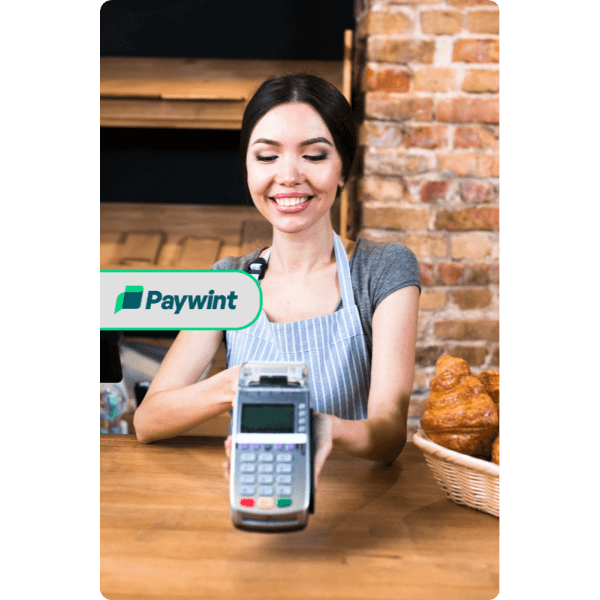 Seamless Integration for Businesses (2) A Smiling Woman in an Apron Holding a POS Terminal, with the Paywint Logo Displayed