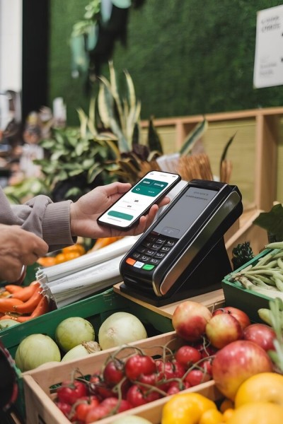Flexible Payment Options for Maximum Convenience A Person Making a Contactless Payment at a Fresh Produce Stand Using a Digital Wallet