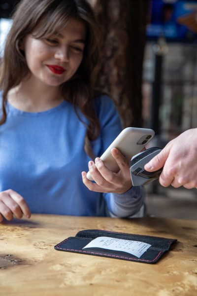 Secure and Reliable Transactions Woman Using a Smartphone for a Seamless Contactless Payment