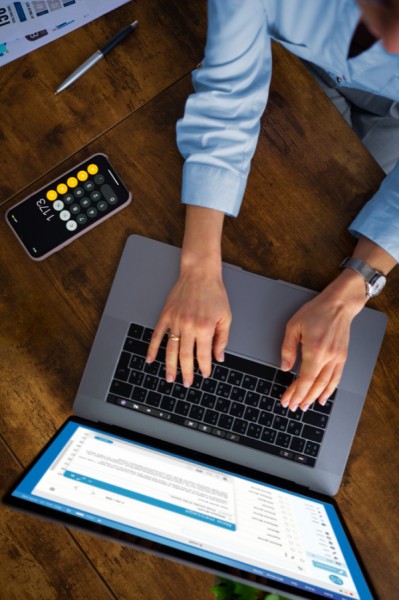 Stay on Top of Payments Person Managing Transactions on Paywint with a Calculator Nearby