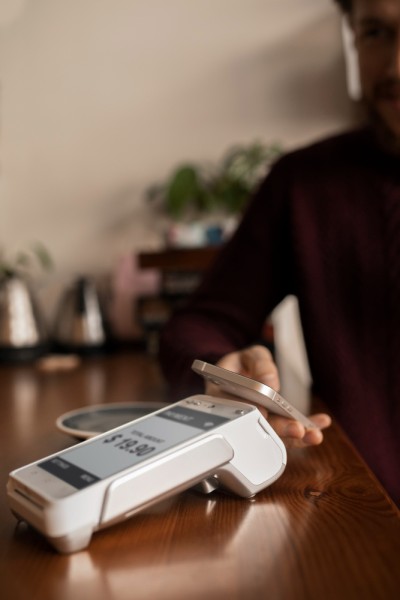 Let Customers Pay Their Way Mobile Expense Tracking Categories on a Smartphone Surrounded by Receipts