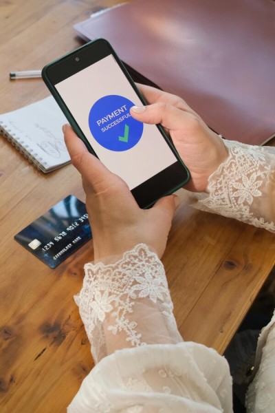 Pay Bills Online from Anywhere Mobile Expense Tracking Categories on a Smartphone Surrounded by Receipts